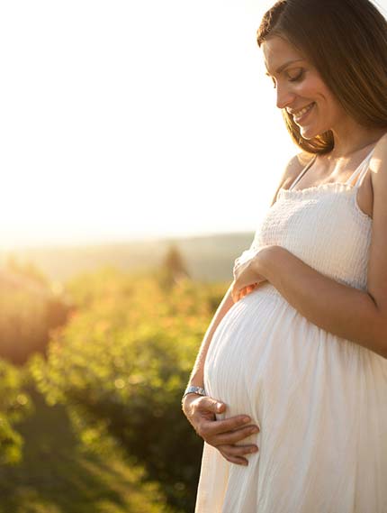 Birth Mom smiling at her pregnant belly